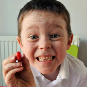 Jack with his big cheesy smile holding a pen