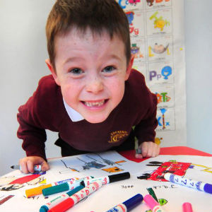 Jack leaning forward over his drawings and pens