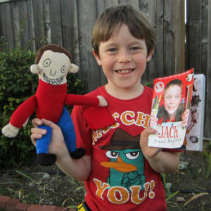 Jack with his book and a toy made for him by Brazilian company Rabisquedo